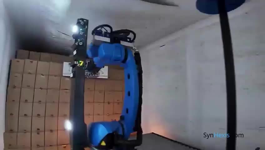 Tracked robot unloading cartons from a container